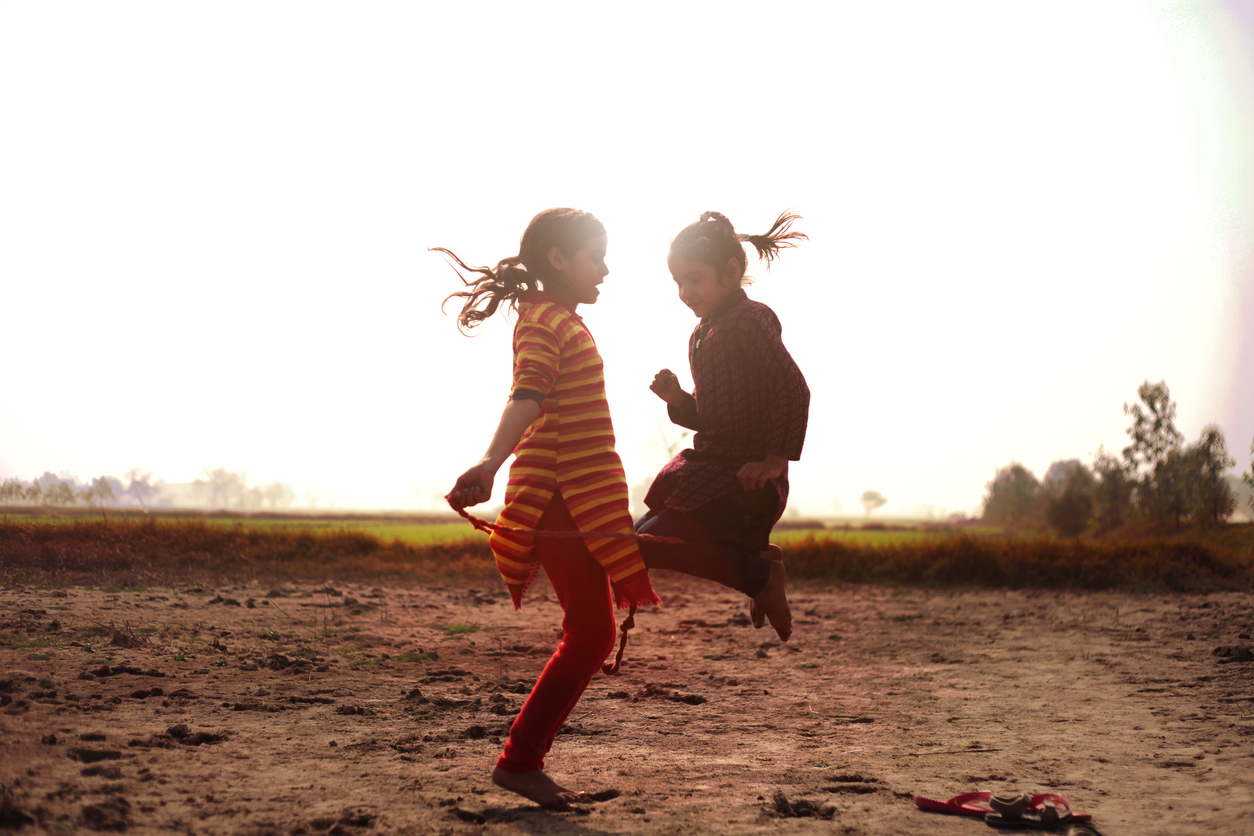 Children playing with jumping rope outdoor in the nature